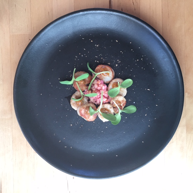 Black Plate, Scallops, Pink Apple, sunflower sprouts